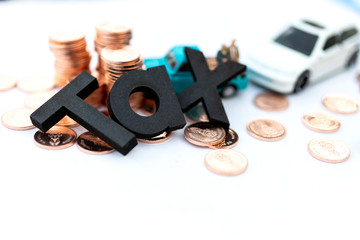 Wooden text is TAX. Image use for Tax calculation every year for everyone, Annual car tax, business concept