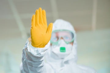 Female epidemiologist gesturing stop sign