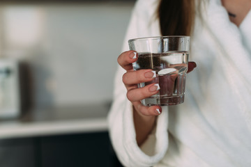 Close up of a glass of water in female hands.
