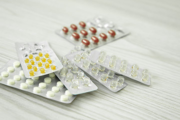 packs of different pills lie on a white background
