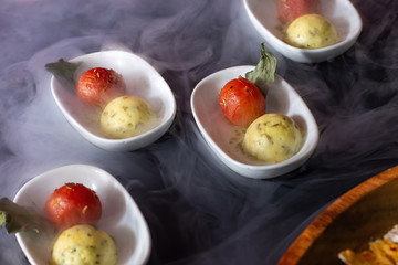 Snacks, ball-shaped fish paste with cherry tomatoes.