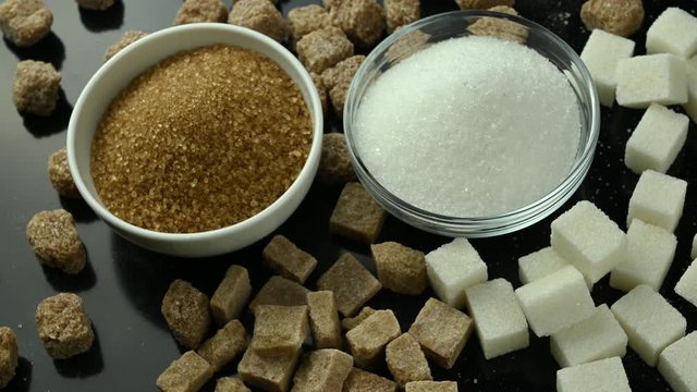 several types of sugar spinning on black table