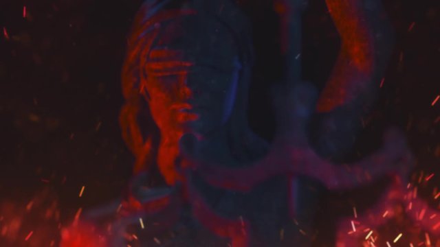Bloody, burning justice: a 3D animation of Lady Justice, goddess Justitia, picturing injustice or discrimination. Close up.