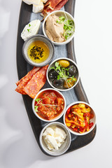 Wooden tray with snacks top view