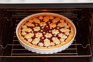 Homemade cherry pie crostata cooked in the domestic oven. Shallow focus.
