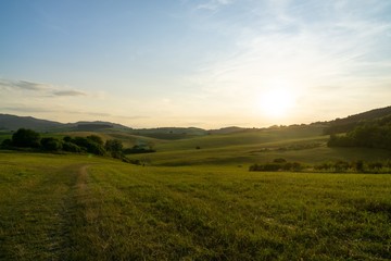 Obraz premium Sunrise or sunset over the hills and meadow. Slovakia