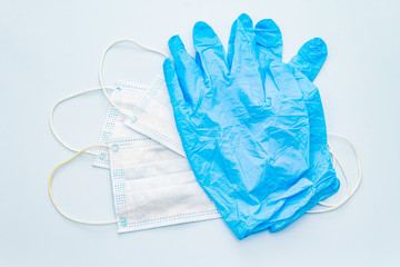 Mask and gloves isolated on blue background
