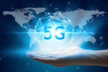 World map with 5G technology background, hand holding network using 5G technology with virtual screen icons on a black background, Technology Internet 5G global network concept.