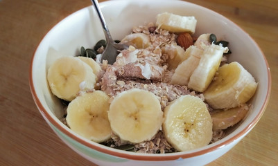 Sliced banana with seeds and yougurt granola bowl