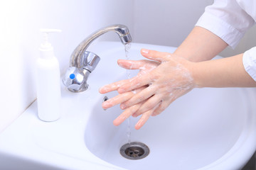 A female doctor washes her hands thoroughly.  Pandemic virus COVID-19
