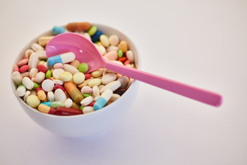 Drug addiction concept with cup full of medicine