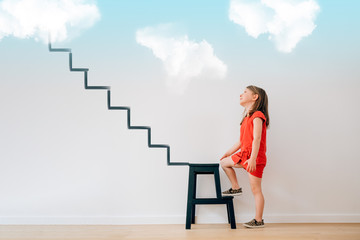 little girl begin to climb the stairs that lead to heaven - life future dreams targets goals illusions planning grow motivation concept © Carlo Prearo