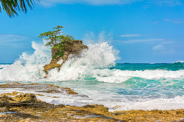 Beautiful waves crash into rocks. Holiday mood