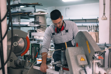 Aluminium and PVC industry worker making PVC or aluminium frames for windows and doors