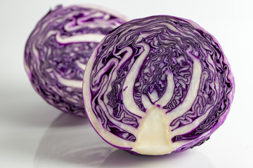 Close up of two halves red cabbage on white background