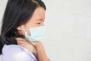 asia women wearing hygienic mask to prevent the virus PM2.5, Coronavirus, (2019-nCoV) asian little girl feeling unwell and coughing as symptom for cold or pneumonia,bronchitis. healthcare concept.