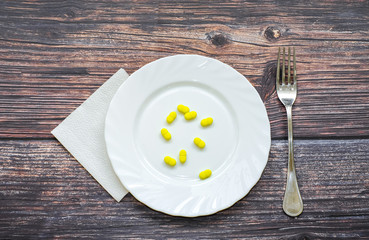 Tablets in plates on a wooden table