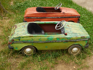 Big old toy cars in summer garden, outdoors