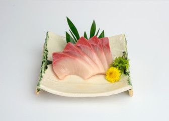 Sliced raw Hamachi sashimi on plate
