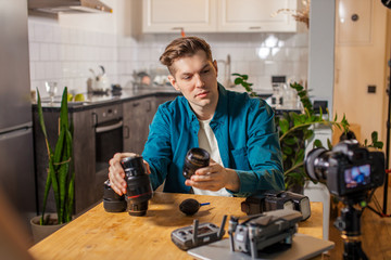 Fototapeta premium intelligent smart photographer keen on blogging, man present new DSLR camera, show and talk about it for subscribers