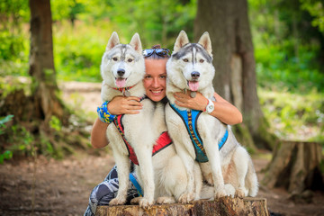woman and her two dogs siberian husky