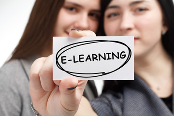 Business, technology, internet and network concept. Young businessman shows a keyword: E-learning