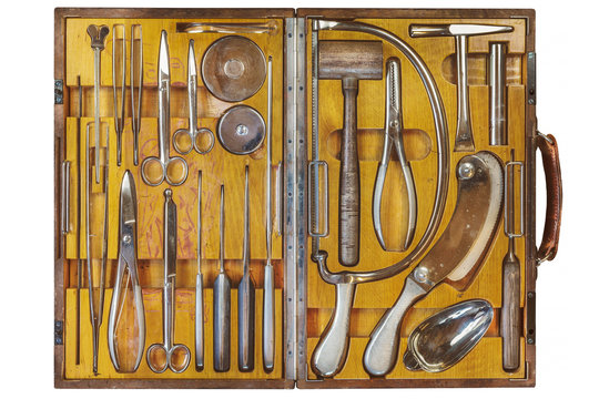Ancient doctor wooden case with surgical equipment isolated on a white background