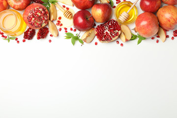 Apple, honey and pomegranate on white background, space for text