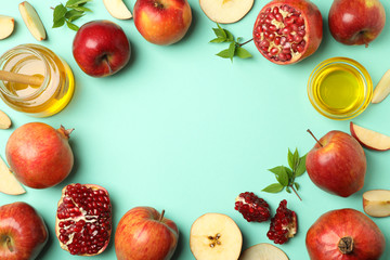 Apple, honey and pomegranate on mint background, space for text