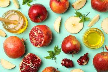 Flat lay with apple, honey and pomegranate on mint background