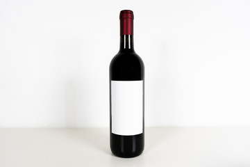 Set of red wine with white mockup label in a white desk and white background