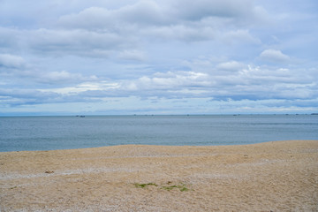 seascape, cloudy sky, blue sea and golden sand beach