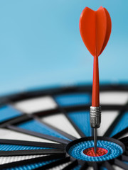 Fototapeta premium Close-up of dart stuck in bull's-eye with copy space