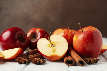 Apple and cinnamon on wooden background, close up