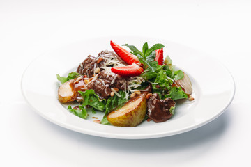 salad of pears, strawberries and greens on a white background