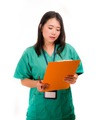 young beautiful and confident Asian Chinese medicine doctor or hospital nurse woman holding medical reports clipboard wearing scrubs isolated on white background