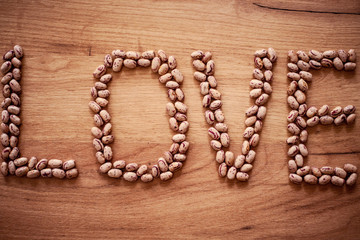 The word love written in beans on table.