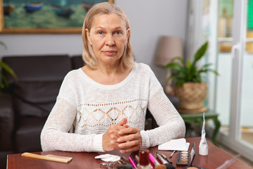Elderly Woman Putting On Make-Up at Home