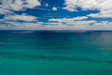 Aerial ocean horizon with blue sky and clouds