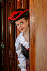 beautiful girl in steampunk costume in an old train carriage