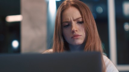 Thoughtful concerned caucasian young woman works on laptop computer think solving problem at modern apartment serious woman search for inspiration make decision feel lack of ideas close up freelancer