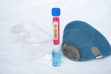 Coronavirus protection, COVID-19 glasses, medical mask. Flasks with red and blue liquid and coronavirus on a white background