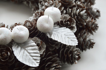 A wreath of cones. Decoration for Christmas and New year. Beautiful decor for a festive interior.