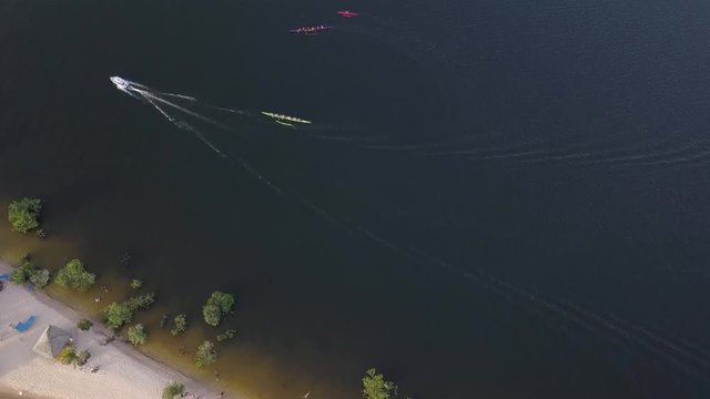 Aerial drone view of motor boat and Hawaiian canoes sailing on Alter do Chao beach on the Tapajos River in the Amazon rainforest. Concept of sport, environment, travel, holidays, tourism and leisure4K