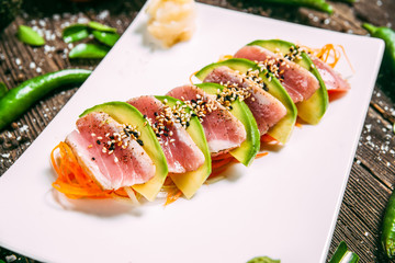 Salad with seared tuna, avocado and carrot, delicious seafood, side view, horizontal, white plate