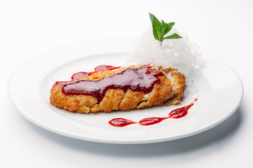 chop on a plate with red sauce