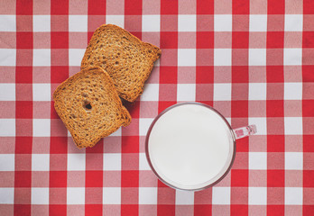 Healthy breakfast on red tablecloth with milk and biscuit