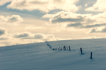The border of the land on a hill under the snow