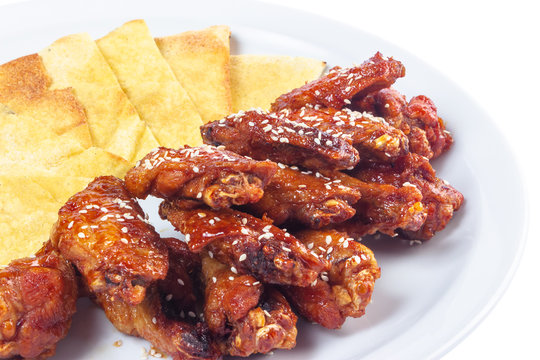 chicken wings in spicy sauce. popular pub dish. beautiful junk food concept. isolated on a white plate.