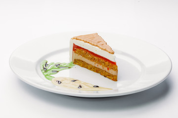 Delicious sliced carrot cake on a white background